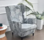 uzvalkalas-foteliui-su-aukstu-atlosu-pilkas-su-lapu-rastu